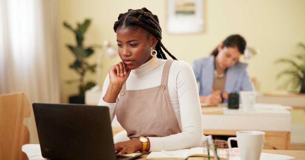 Business woman, laptop and planning in office for research, networking and communication with visio