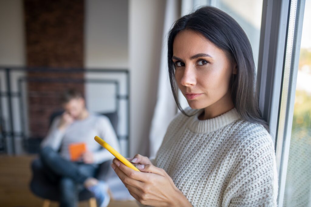 Dark-eyed wife feeling suspicious while feeling jealous