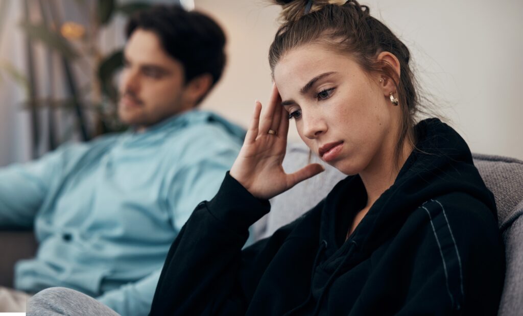 Frustrated couple, headache and fight on sofa in divorce, disagreement or conflict in living room a