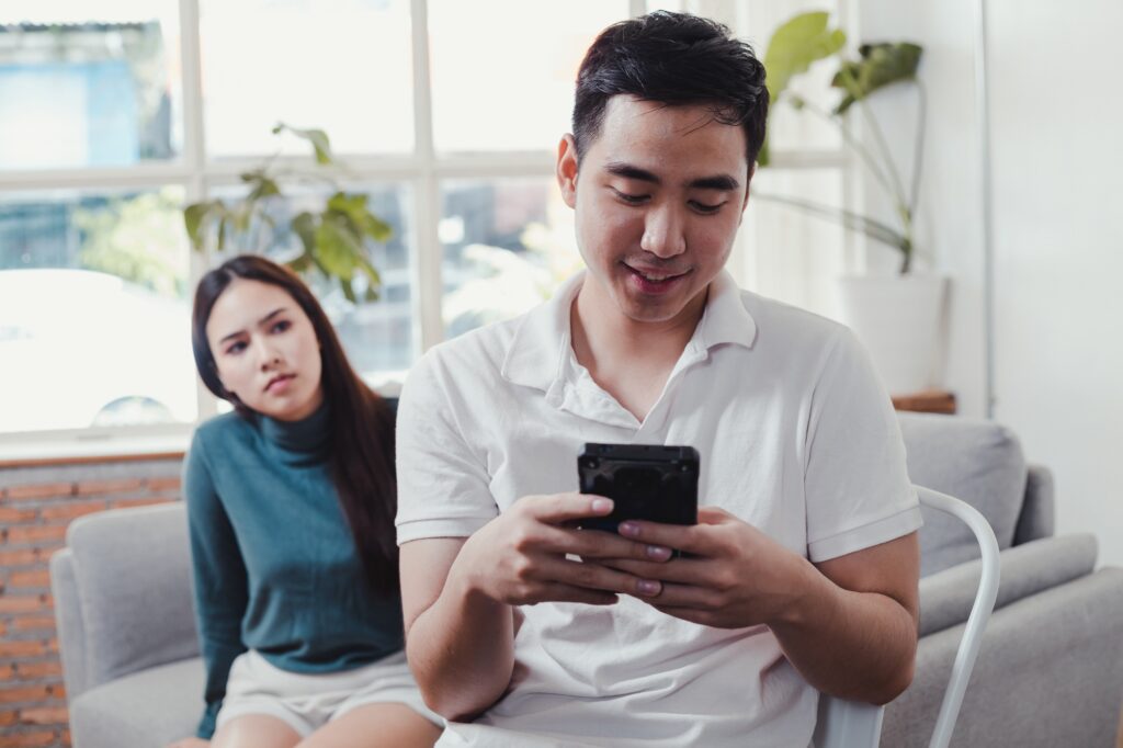 Woman are angry that man playing on the phone and not interested.